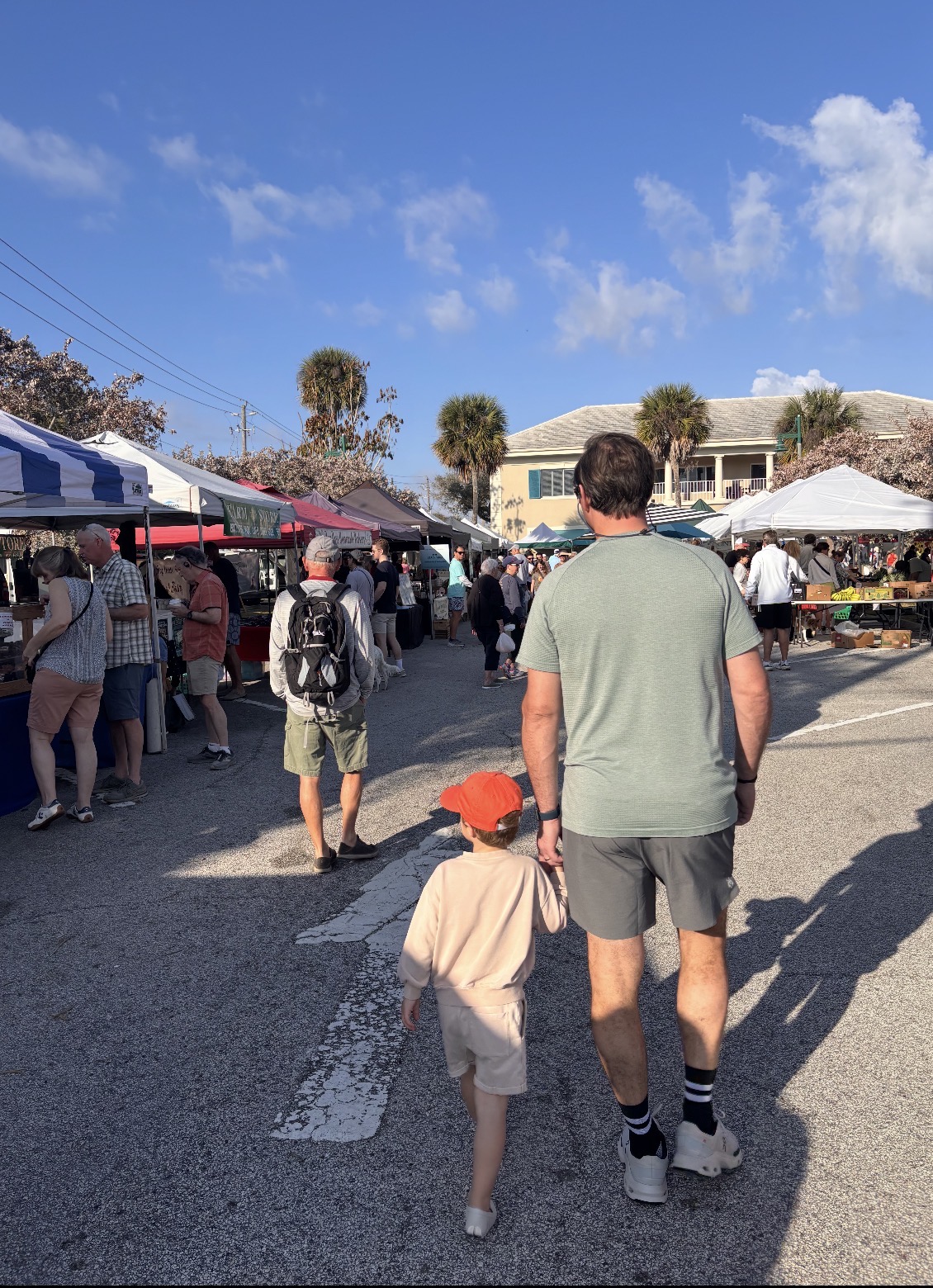 Dad and child walking through the Vero Beach Farmers Market